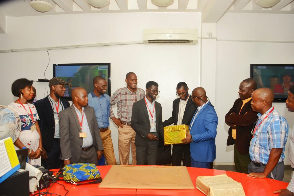 Asu (centre) receives a gift from his colleagues on his last day at Punch 