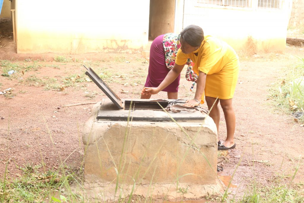 Two ladies fetch from the protected well