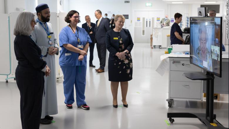 Queen Elizabeth speaking with hospital staff about COVID.