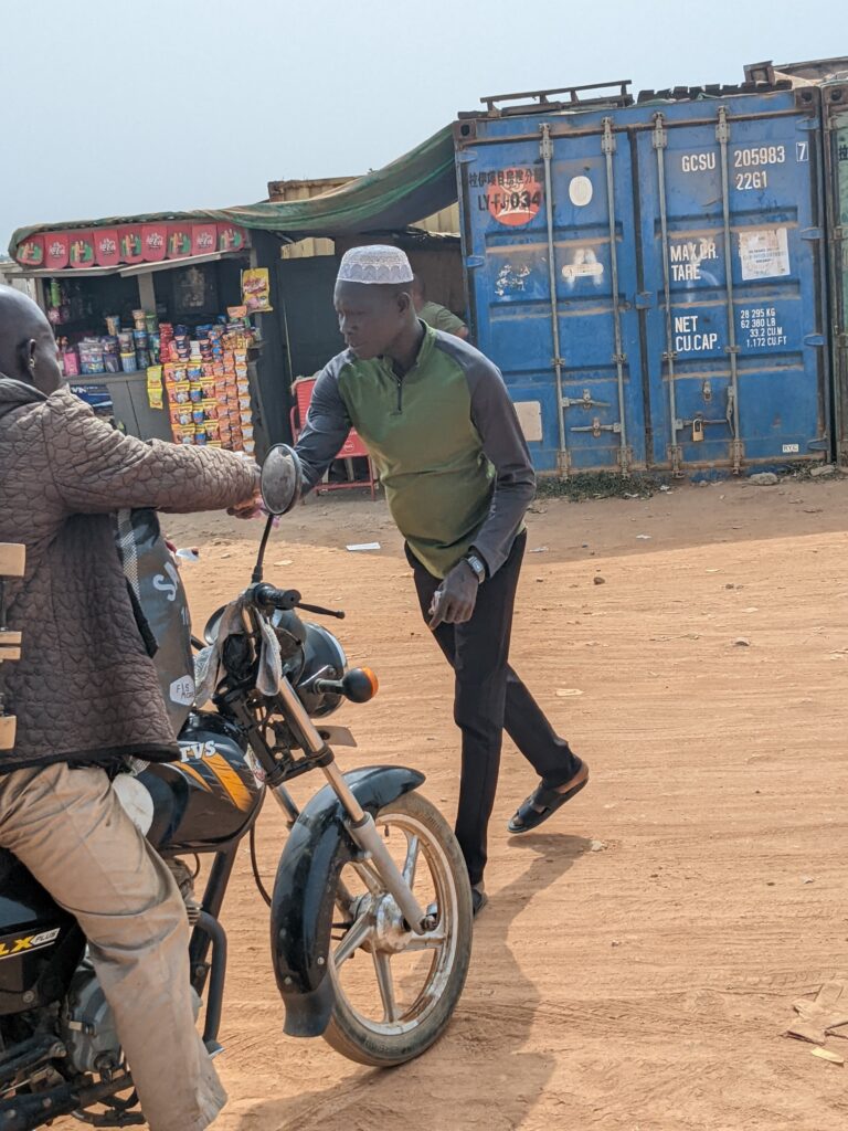 Man collecting dues from a motorcycle operator