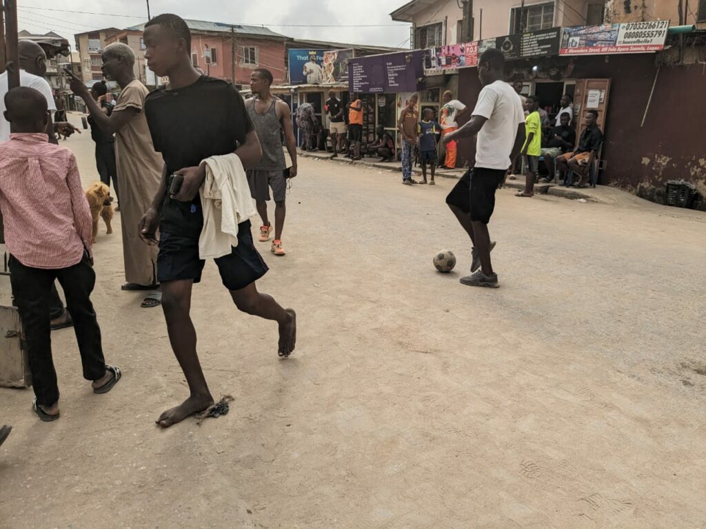 Young men playing football near the polling unit