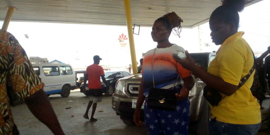 Tobi and another saleslady selling petrol