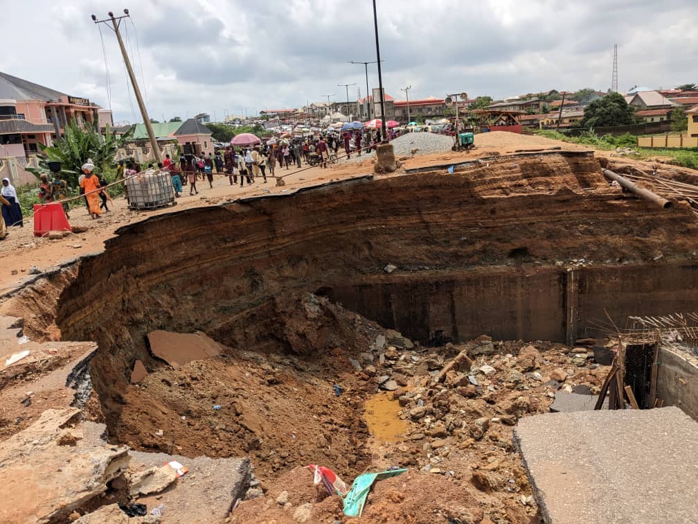 Traders on both sides of the damaged road.