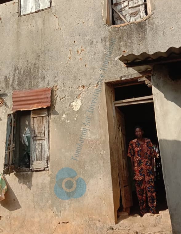 Fatal Lawal standing at the entrance of their house
