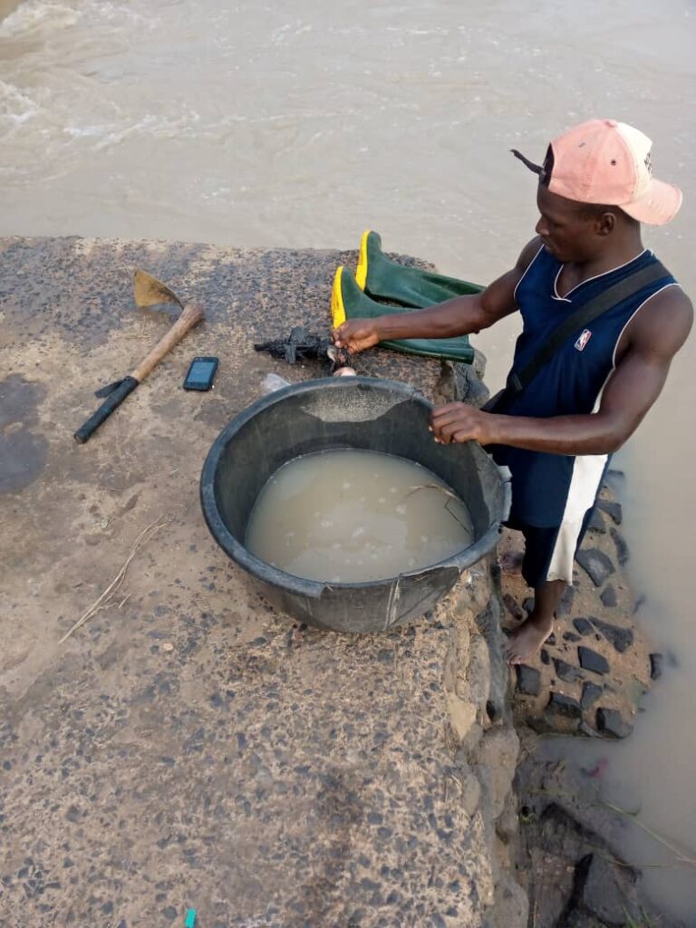 A Casual Worker Washing His Personal Effects With the Contaminated Water